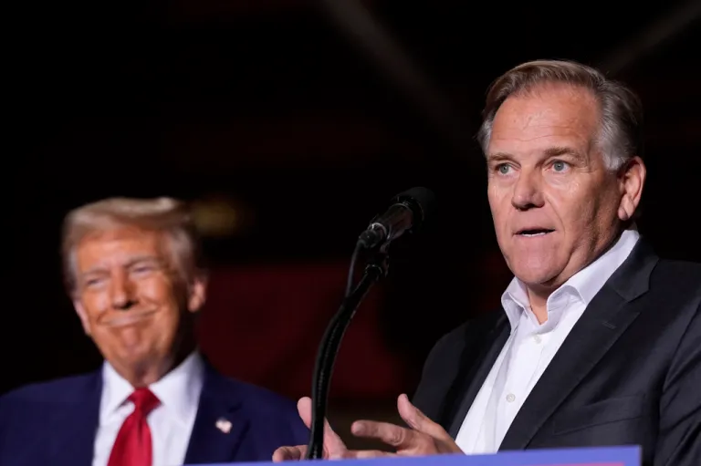 Republican presidential nominee former President Donald Trump listens as Senate candidate former Rep. Mike Rogers, speaks at a campaign event at the Ryder Center at Saginaw Valley State University, Thursday, Oct. 3, 2024, in University Center, Mich. (AP Photo/Alex Brandon)