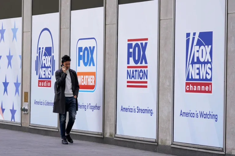 FILE - A man walks past the News Corp. and Fox News headquarters on April 19, 2023, in New York. (AP Photo/Mary Altaffer, File)