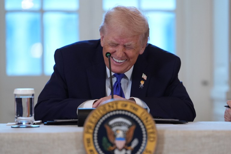 President Donald Trump smiles during a meeting with oil executives
