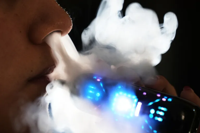 Ximena Fernandez vapes while working remotely from home in Mexico City, Jan. 30, 2026. (AP Photo/Marco Ugarte, File)