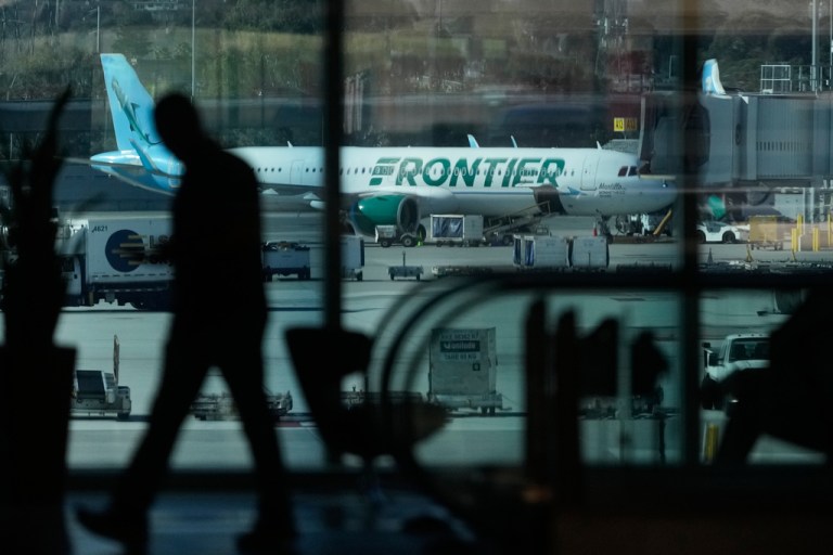 A Frontier Airlines plane is shown at San Francisco International Airport.