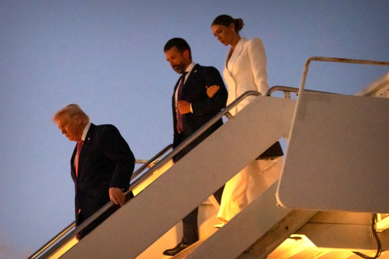 President Donald Trump, followed by his son Donald Trump Jr., and Bettina Anderson step off Air Force One.