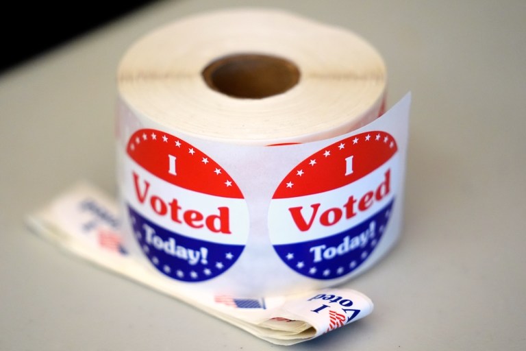 A spool of stickers rests on a table at a polling station during Massachusetts state primary voting, Sept. 3, 2024.