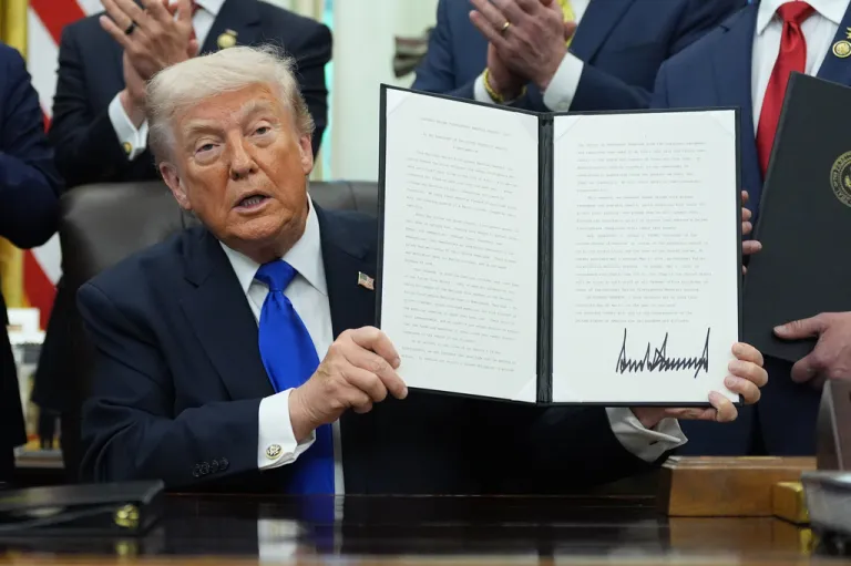 President Donald Trump signs a presidential proclamation.