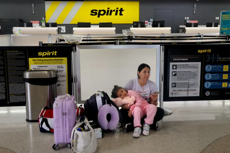 Vanessa Potosi and her 4-year-old daughter, Emiliana Cardona, sit at a Spirit Airlines check in as their flight was cancelled at Fort Lauderdale-Hollywood International on Saturday, May 2, 2026.