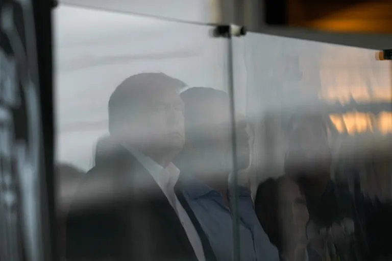President Donald Trump watches play on the 18th hole during the final round of the Cadillac Championship PGA golf tournament.