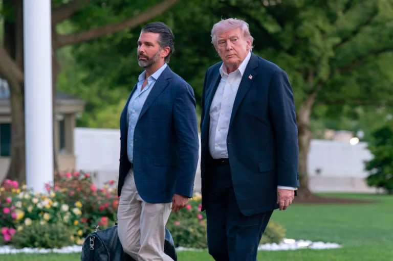 President Donald Trump and Donald Trump Jr. walk on the South Lawn upon their arrival to the White House, Sunday, May 3, 2026, in Washington.