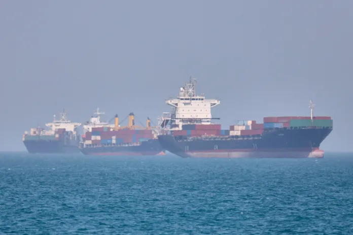 Container ships sit at anchor in the Strait of Hormuz off Bandar Abbas, Iran, Saturday, May 2, 2026.