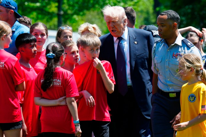 President Donald Trump walks with kids during exercise drills on the south lawn of the White House, Tuesday, May 5, 2026, in Washington.