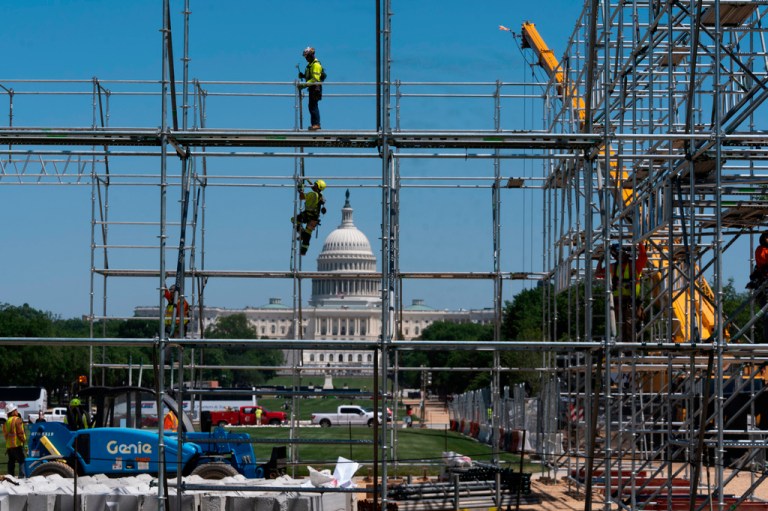 Workers erect scaffoldings