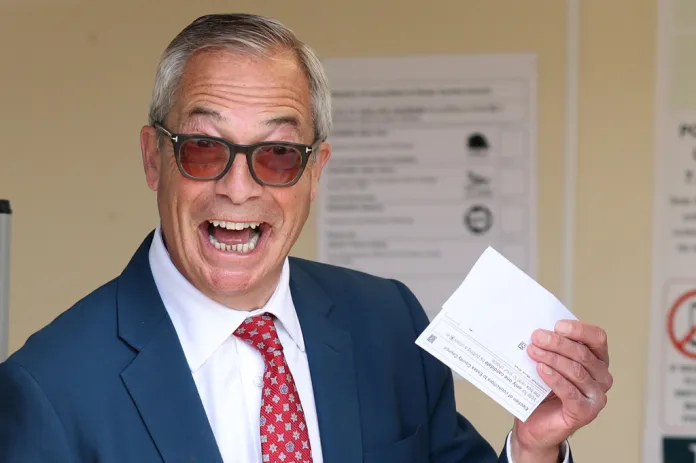 Nigel poses with his ballot at a polling station