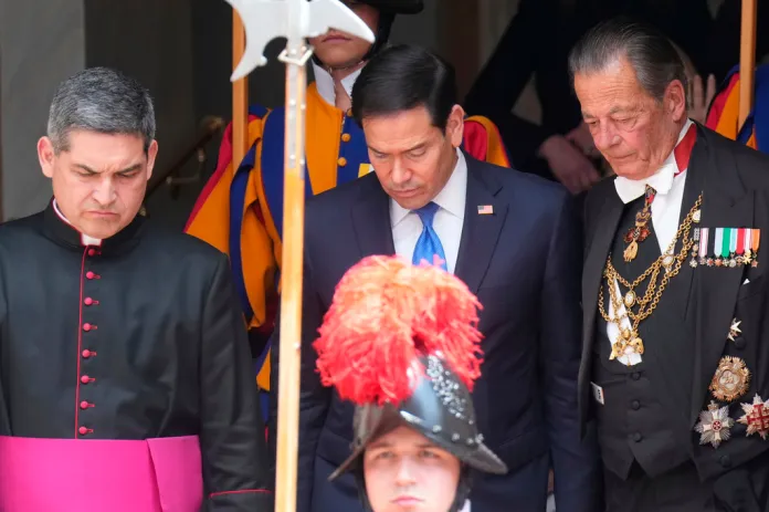 Rubio walks beside clerics and gentlemen of His Holiness at the Vatican