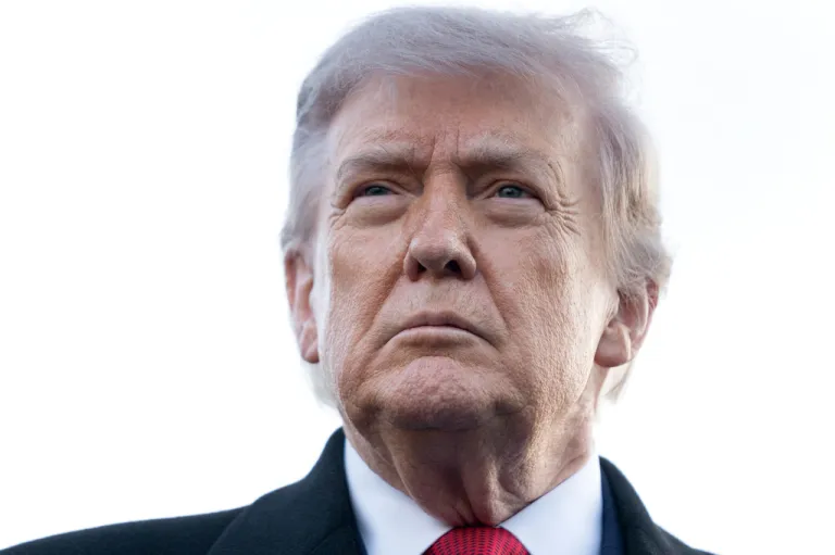 President Donald Trump listens to a reporter's question.