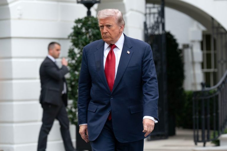 President Donald Trump walks to speak with reporters.