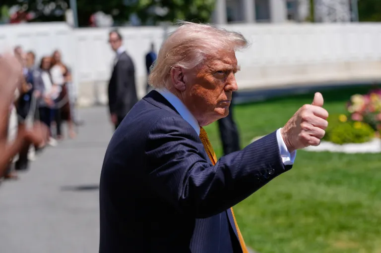 President Donald Trump gives a thumbs up as he leaves the White House