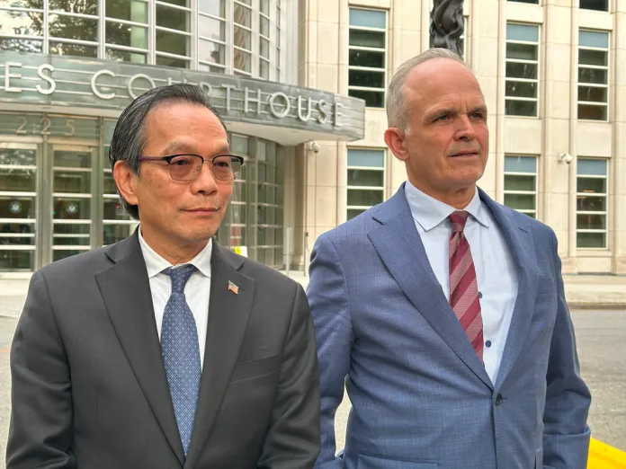 Lu Jianwang stands with his lawyer, John Carman, outside a U.S. courthouse in Brooklyn, New York, on Wednesday, May 13, 2026, following his conviction of acting as an illegal foreign agent for China. 