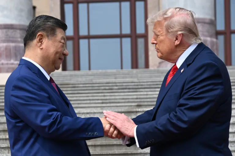 Chinese President Xi Jinping, left, shakes hands with U.S. President Donald Trump at the Great Hall of the People in Beijing, Thursday, May 14, 2026.