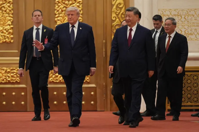 President Donald Trump, left, and Chinese President Xi Jinping, center, arrives during a state dinner at the Great Hall of the People on Thursday May 14, 2026, in Beijing.