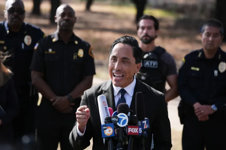 Todd Gloria speaking into microphones