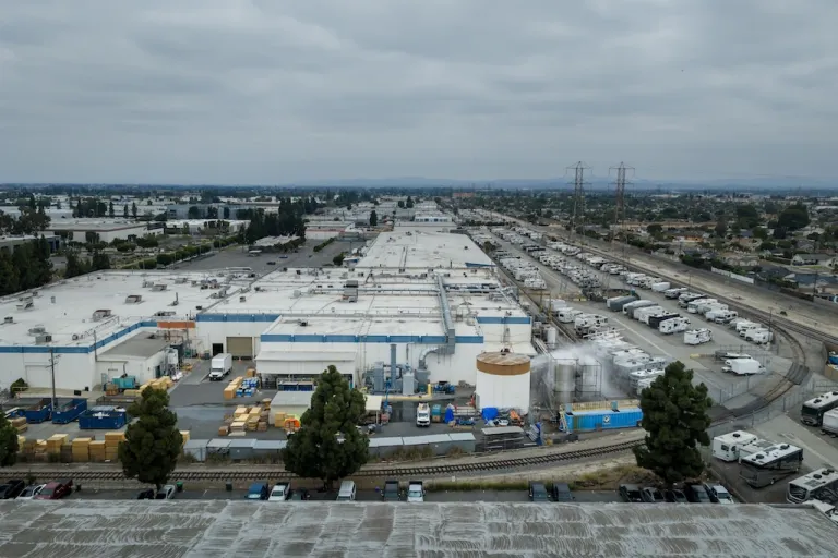 Water is sprayed on a damaged tank at GKN Aerospace in Garden Grove, Calif., on Sunday, May 24, 2026, after the tank containing a chemical used to make plastic parts overheated Thursday. (AP Photo/Ethan Swope)