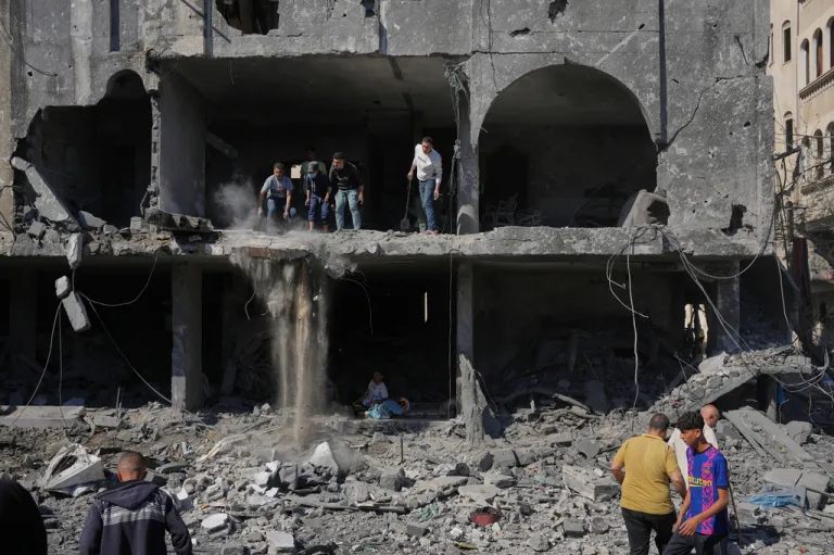Palestinians inspect the rubble of a building destroyed in an Israeli airstrike in Nuseirat, central Gaza Strip, Tuesday, May 26, 2026.