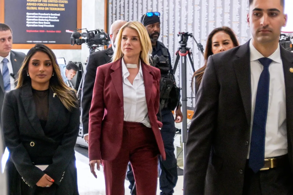 Former Attorney General Pam Bondi, center, arrives for her deposition at the Rayburn House Office Building on Capitol Hill.