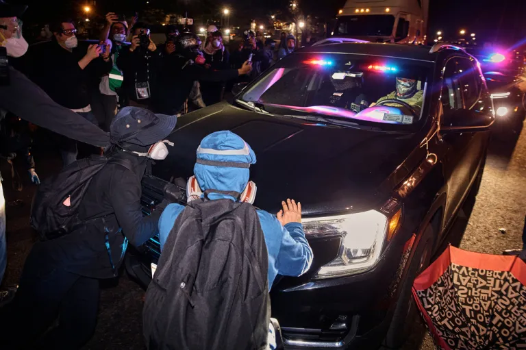Protesters block ICE cars outside the Delaney Hall detention center during a protest against the transfer of detainees and federal immigration policies,, Friday, May 29, 2026, in Newark, N.J. (AP Photo/Andres Kudacki)