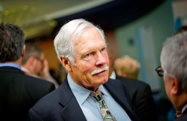 In this Dec. 6, 2013, photo, Ted Turner talks with guests at the Captain Planet Foundation benefit gala in Atlanta.