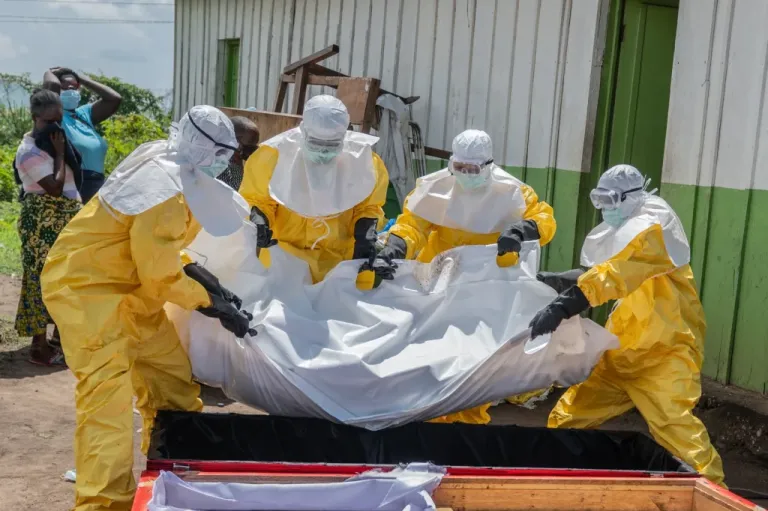 Red Cross workers cary body of person who died from Ebola in the Congo.