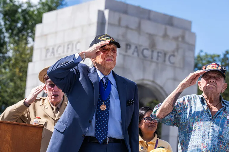 U.S. Merchant Marine veteran Dave Yoho, left, 97, of Fairfax, Va., and Navy veteran Eddie Janek, 98, of Galveston, Texas, who fought in the battle of Battle of Peleliu, salute wile listening to the National Anthem during a ceremony to mark the 80th anniversary of V-J Day at the National World War II Memorial on Tuesday, September 2, 2025. (Tom Williams/CQ-Roll Call, Inc via Getty Images)