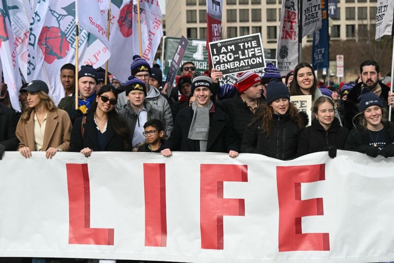 People hold a giant banner as they march through Pennsylvania Avenue during the 53rd annual March for Life rally.