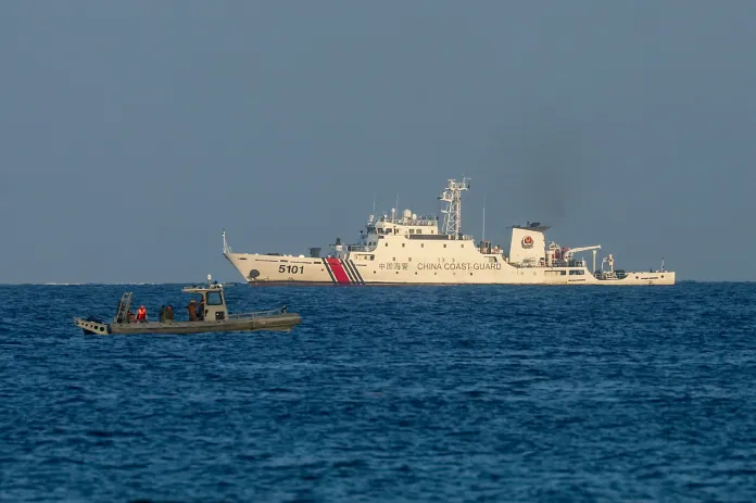A Philippine Marine speedboat patrols off the coast of Manila-ruled Thitu Island while a China Coast Guard vessel nears it, in the disputed South China Sea, on May 3, 2026. The Philippine-ruled Thitu Island, also known as Pagasa, is part of the Spratly Island groups in the South China Sea, disputed by neighboring countries including Beijing, Manila and Vietnam. Recent reports have shown that China has significantly increased its People's Liberation Army and Coast Guard presence in the contested waters. United States and other nations have issued statements in response to actions that fueled geopolitical tensions in the region. (Photo by Daniel Ceng/Anadolu via Getty Images)