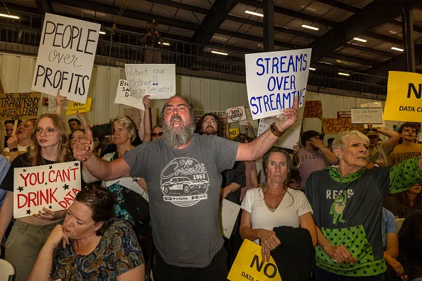 TREMONTON, UTAH - MAY 4: Petitioners react as the Box Elder County county commission announces approval of a large data center on May 4, 2026 in Tremonton, Utah. The commission approved the construction of a 40,000 acre data center near the north shore of the Great Salt Lake. Hundreds of protesters came to the meeting to oppose the plan.  