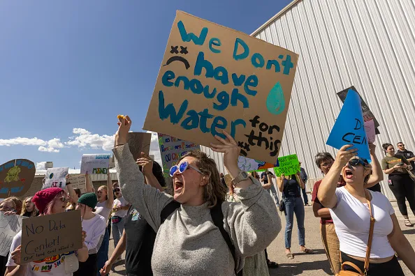 TREMONTON, UTAH - MAY 4: Protesters gather ahead of a Box Elder County County Commission meeting to decide whether to approve the construction of a large data center on May 4, 2026 in Tremonton, Utah. The commission approved the construction of a 40,000 acre data center near the north shore of the Great Salt Lake. Hundreds of protesters came to the meeting to oppose the plan.  