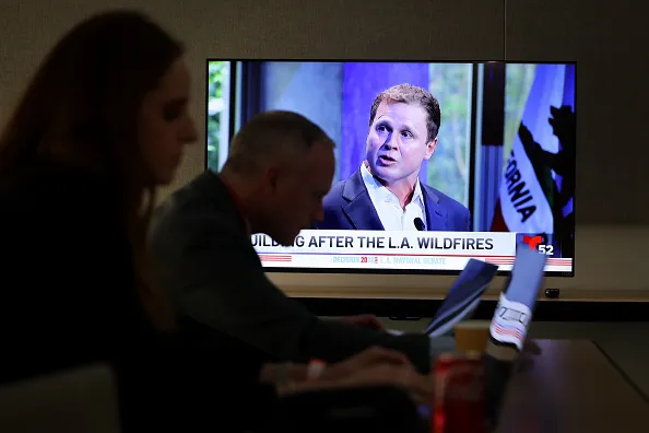 Los Angeles, CA - MAY 06, 2026:  Spencer Pratt is shown on a television while journalists work during the 2026 Los Angeles Mayoral debate at Skirball Cultural Center on Wednesday, May 6, 2026 in Los Angeles, CA. 