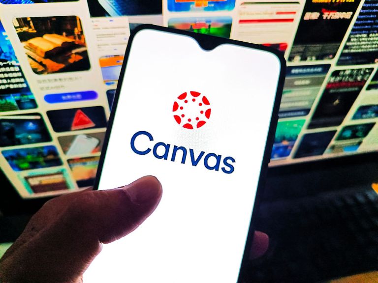 A netizen is viewing the Canvas logo on his mobile phone and the Canvas webpage on his computer in Suqian City, Jiangsu Province, China on May 11, 2026. (Photo credit should read CFOTO/Future Publishing via Getty Images)