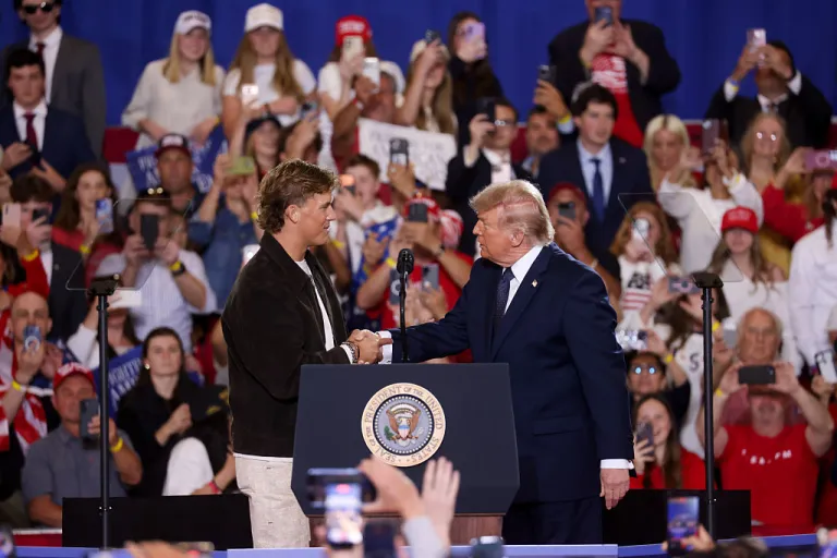 New York Giants quarterback Jaxson Dart and US President Donald Trump shake hands during an event inside Eugene Levy Fieldhouse at Rockland Community College in Suffern, New York, US, on Friday, May 22, 2026. Trump is speaking on his economic accomplishments in the toss-up congressional district represented by Mike Lawler, who is up for reelection in one of the most closely watched Congressional races in the November midterm elections. Photographer: Michael Nagle/Bloomberg via Getty Images