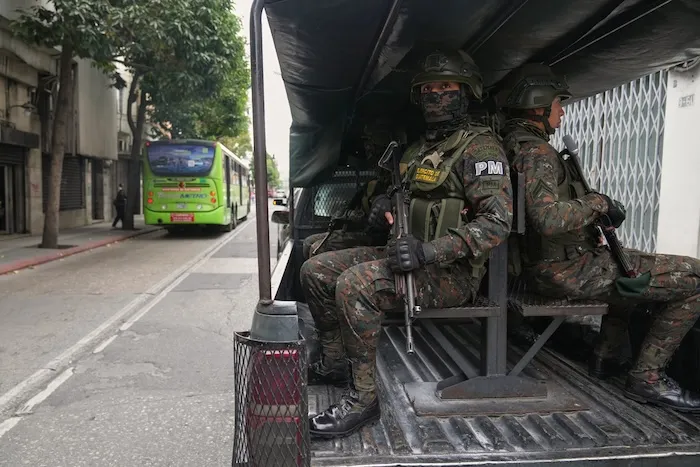 Deployed soldiers stand guard in a vehicle around Congress in Guatemala City, Monday, Jan. 19, 2026, after President Bernardo Arévalo declared a state of emergency. (AP Photo/Moises Castillo)