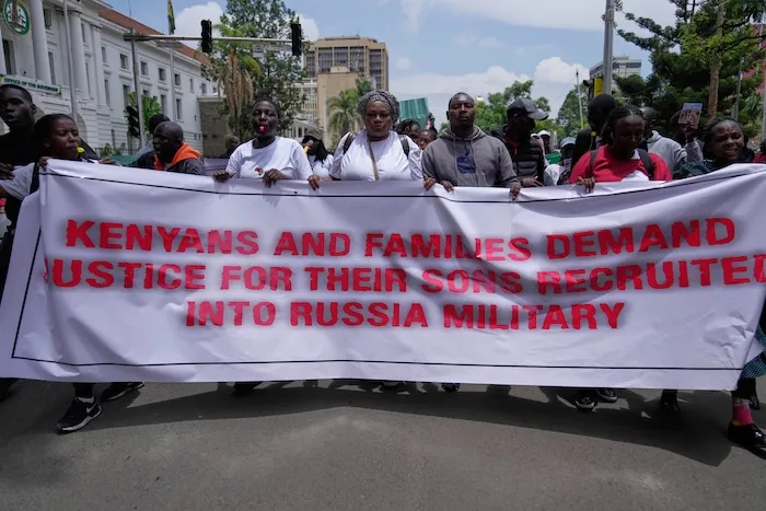 Family members of Kenyans who joined the Russian army in Ukraine hold placards and photos of their loved ones during a protest calling for their repatriation in Nairobi, Kenya, on March 5, 2026.