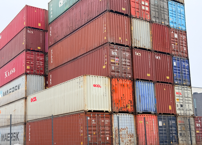 This promotional image from Sensofusion shows one Tactical Drone Factory container hidden among several stacked shipping containers.