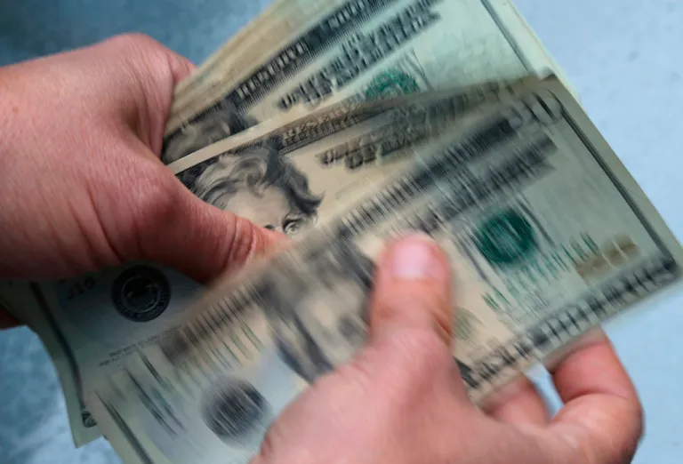 In this June 15, 2018, file photo, twenty dollar bills are counted.