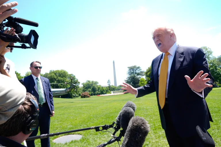 President Donald Trump speaks to reporters as he leaves the White House for travel to Beijing. (AP Photo/Manuel Balce Ceneta)