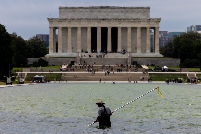 Worker cleans algae from the Lincoln Memorial Reflecting Pool.