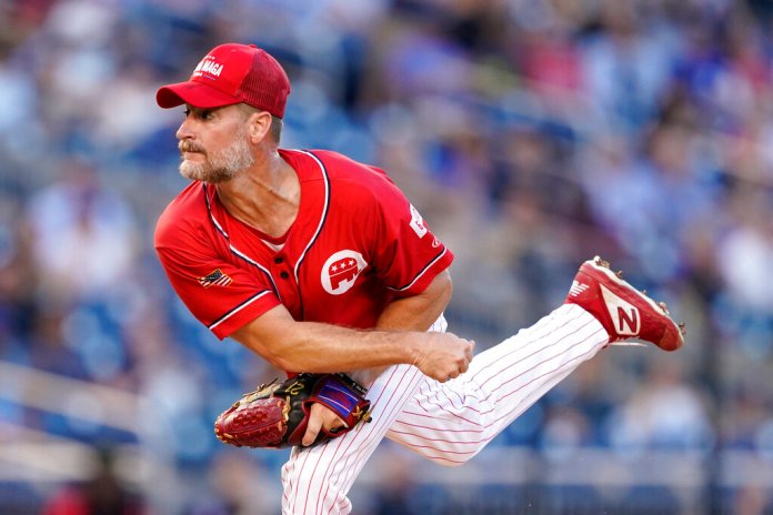 Rep. Greg Steube (R-FL) follows through on a pitch to the Congressional Democrats in the first inning of the Congressional baseball game, Thursday, July 28, 2022, in Washington. (AP Photo/Patrick Semansky)