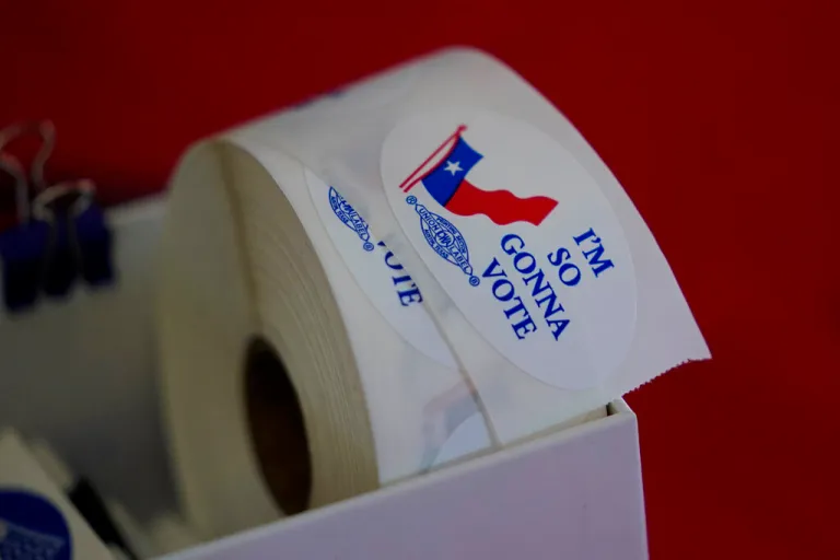 Voting stickers are seen at a political event in Texas
