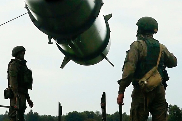 FILE - In this photo taken from video released by the Russian Defense Ministry Press Service on Wednesday, June 12, 2024, Russian soldiers load a Iskander-M short-range ballistic missile launchers at a firing position as part of Russian military drill intended to train the troops in using tactical nuclear weapons.