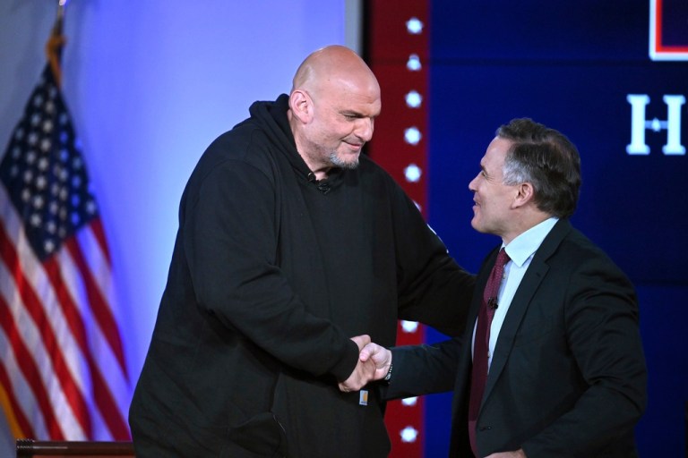 Sen. John Fetterman and Sen. Dave McCormick, R-Pa., right, greet before participating in a debate, Monday, June 2, 2025, at the Edward M. Kennedy Institute for the United States Senate, in Boston, as livestreamed on Fox Nation.