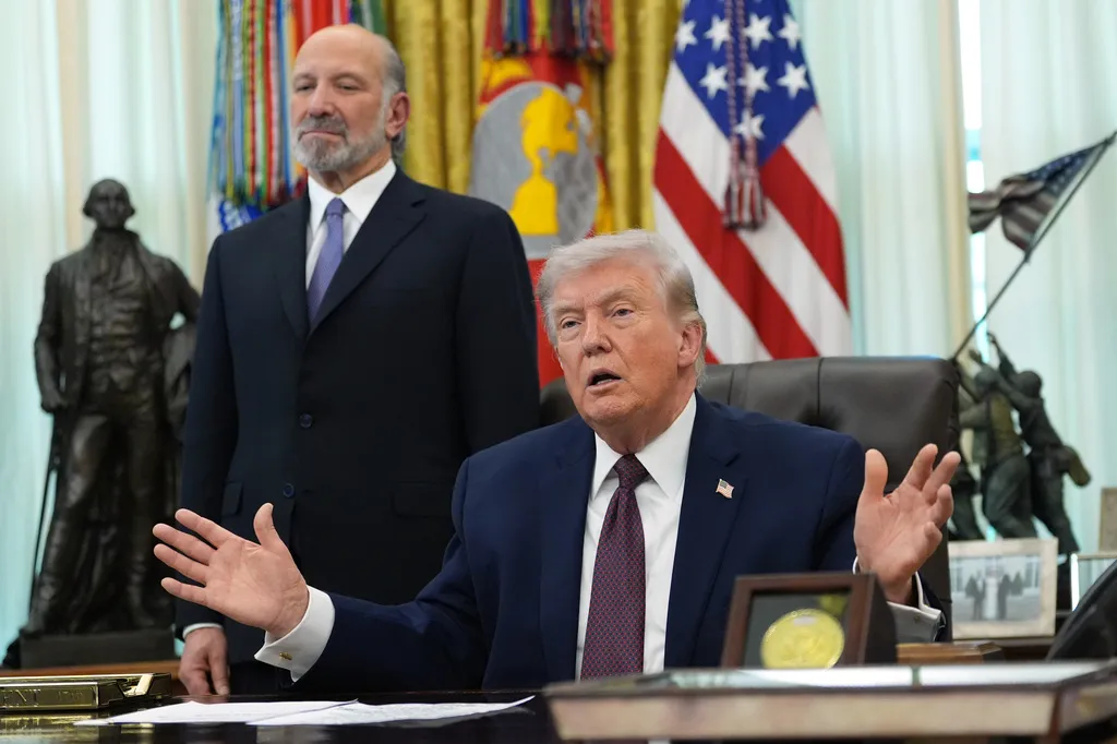 President Donald Trump answers questions from reporters after signing an executive order in the Oval Office.