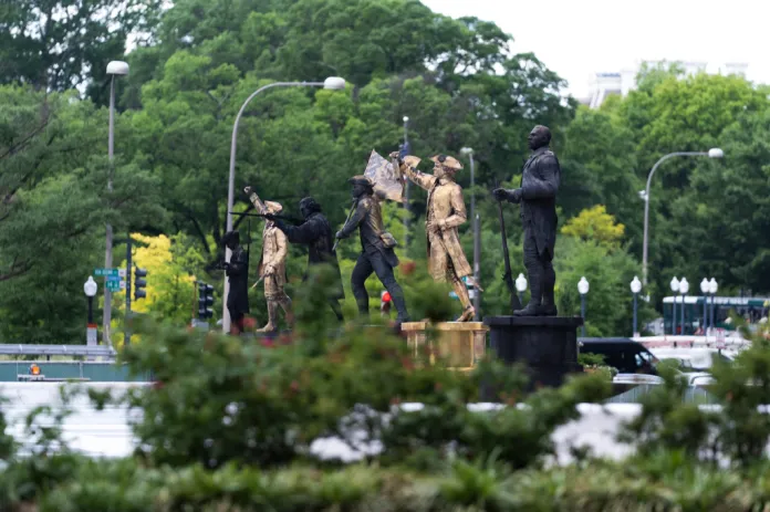 Bronze statues are seen installed at the fenced-off Freedom Plaza