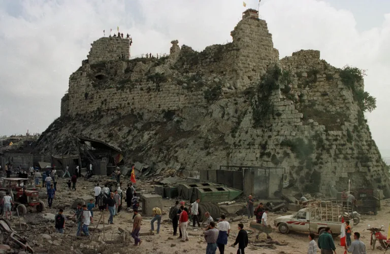Villagers inspect the damage to Beaufort Castle, 10 kilometers (6 miles) northwest of the southern market town of Nabatiyeh, Lebanon, Wednesday, May 24, 2000.